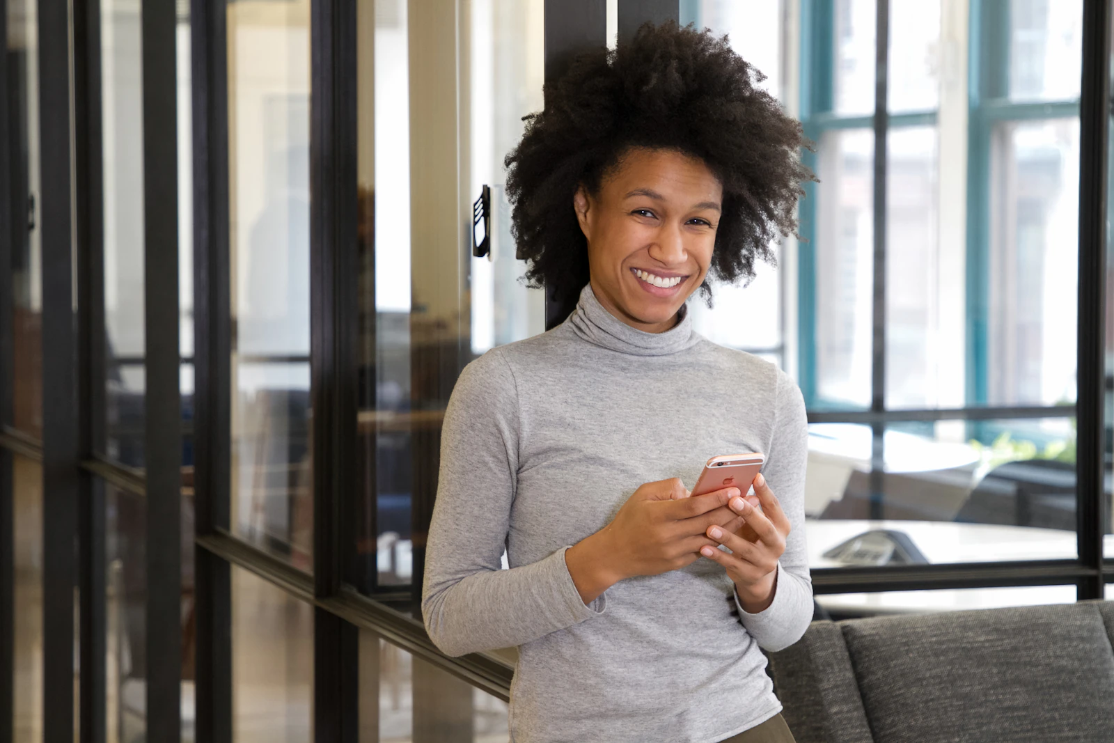 A customer smiling at a text on her phone