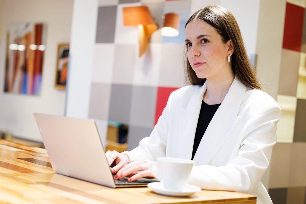 A woman working at her laptop in an office