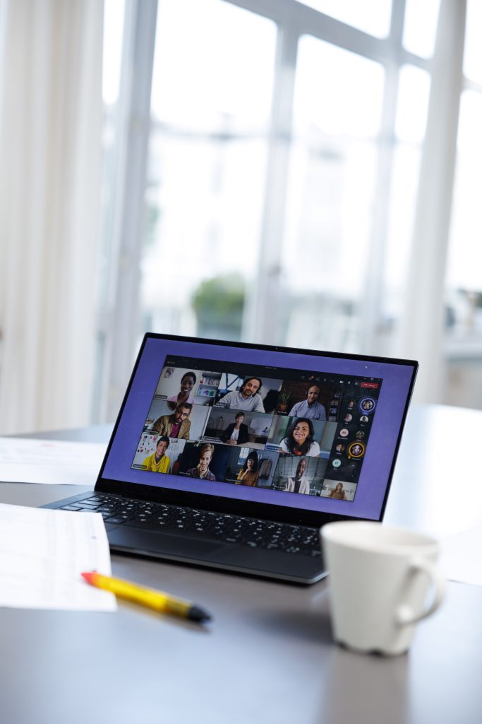 A laptop on a video call with a team of colleagues