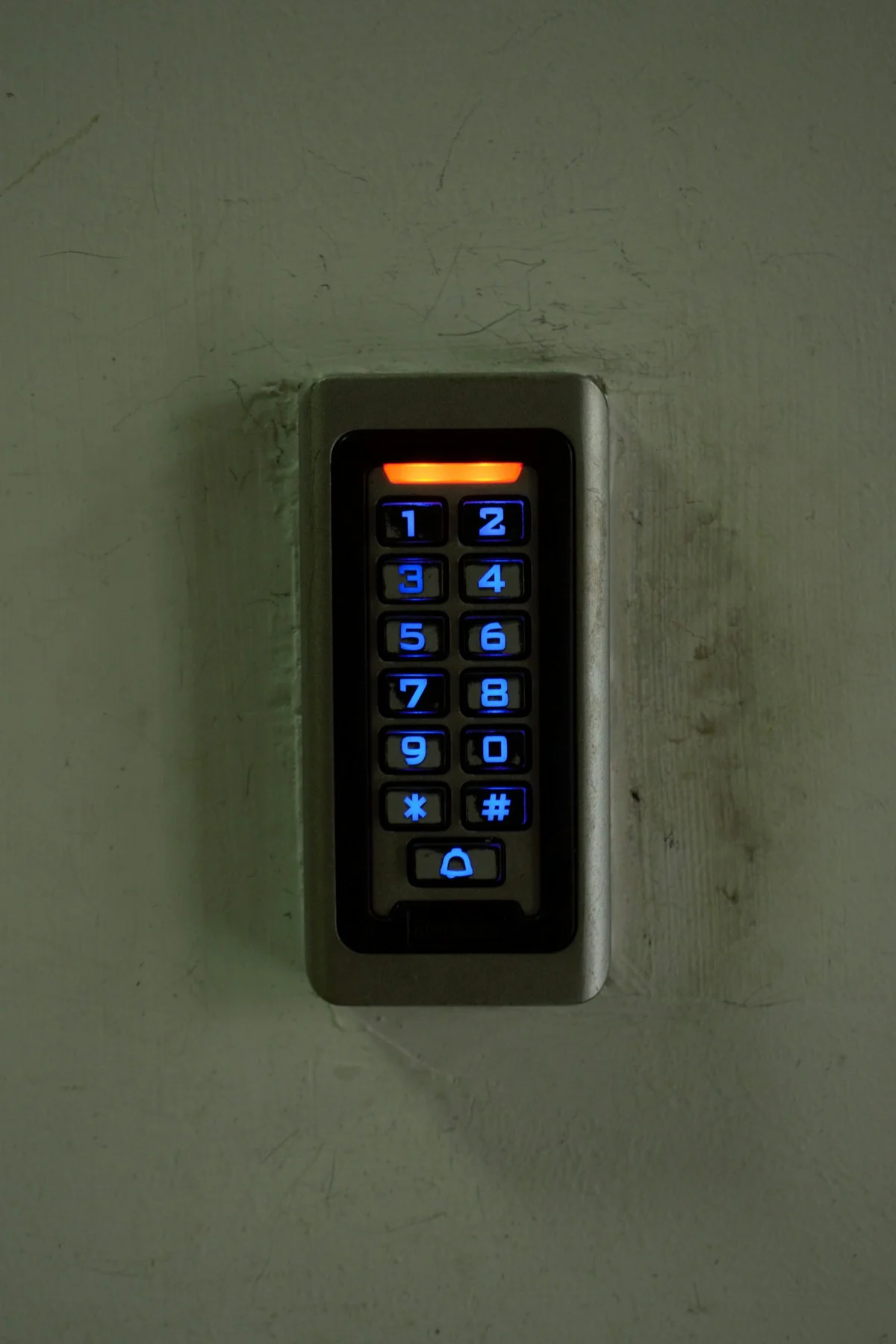 A door keypad mounted on a wall