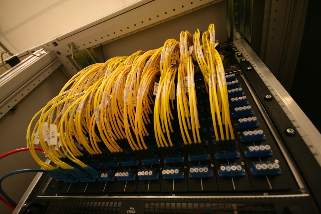 Yellow fibre patch cords on an exchange patch panel
