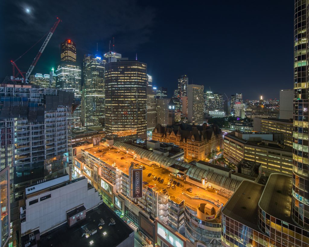 Toronto highways at night from above, lanes lit in streams
