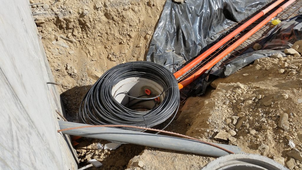 Fibre cables being laid in an open trench