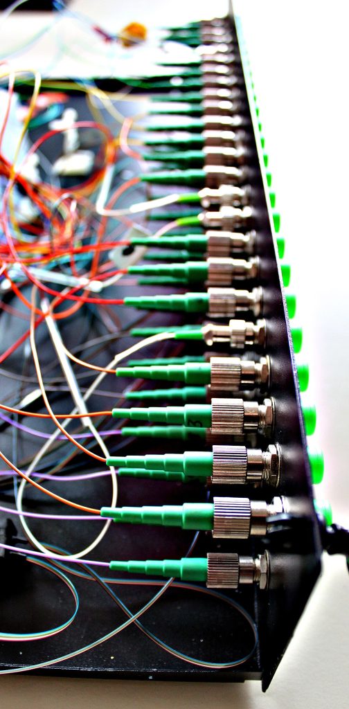 Green fibre connectors plugged into WDM modules