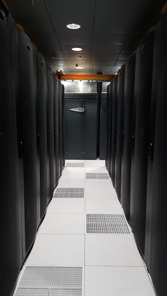 Corridor between black rack cabinets