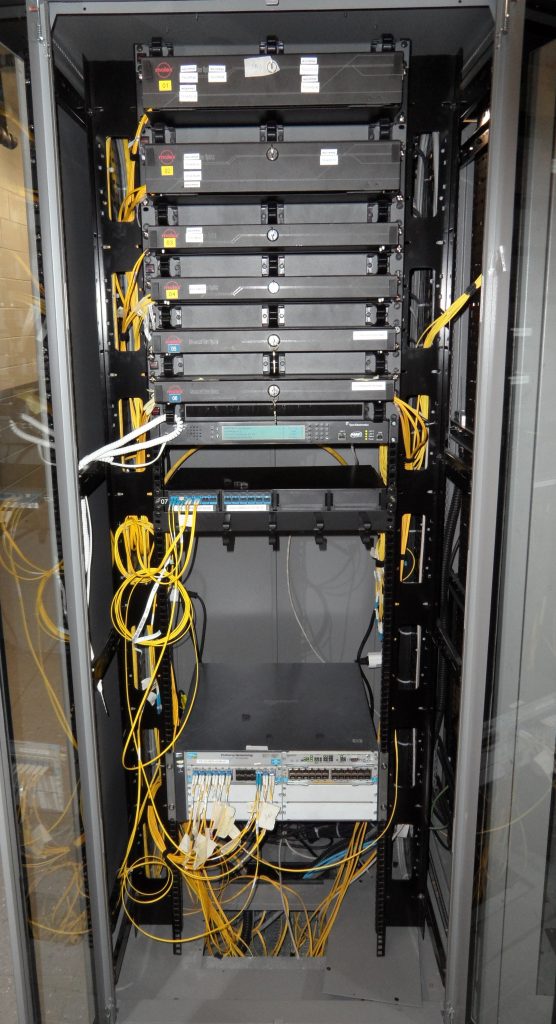 Fibre patch panel with yellow fibres in a rack
