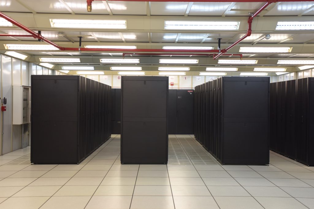 Rows of black rack cabinets in a data hall