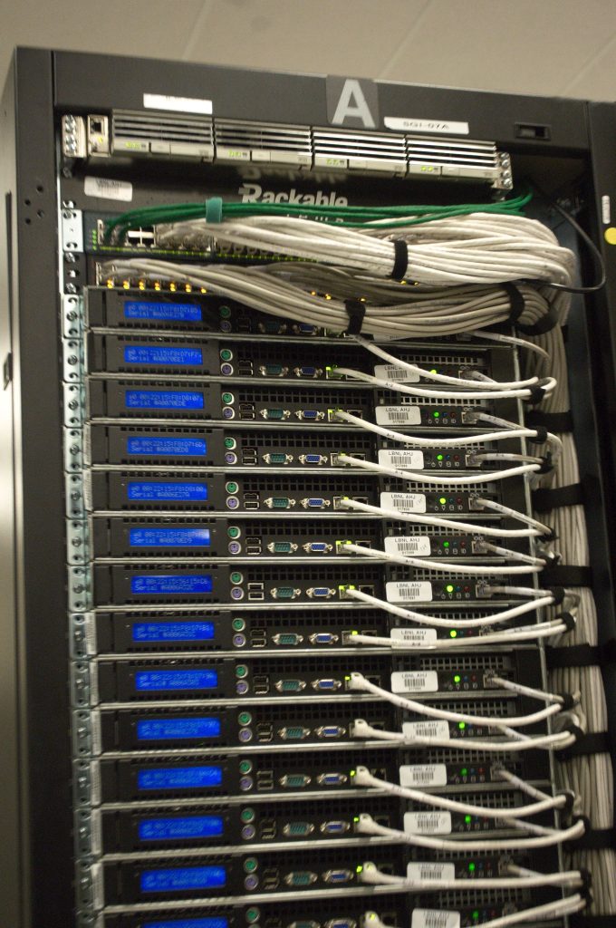 Rear of a rack with white cables and blue status displays