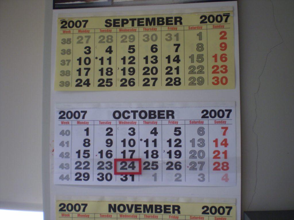 A wall calendar with a date circled in red