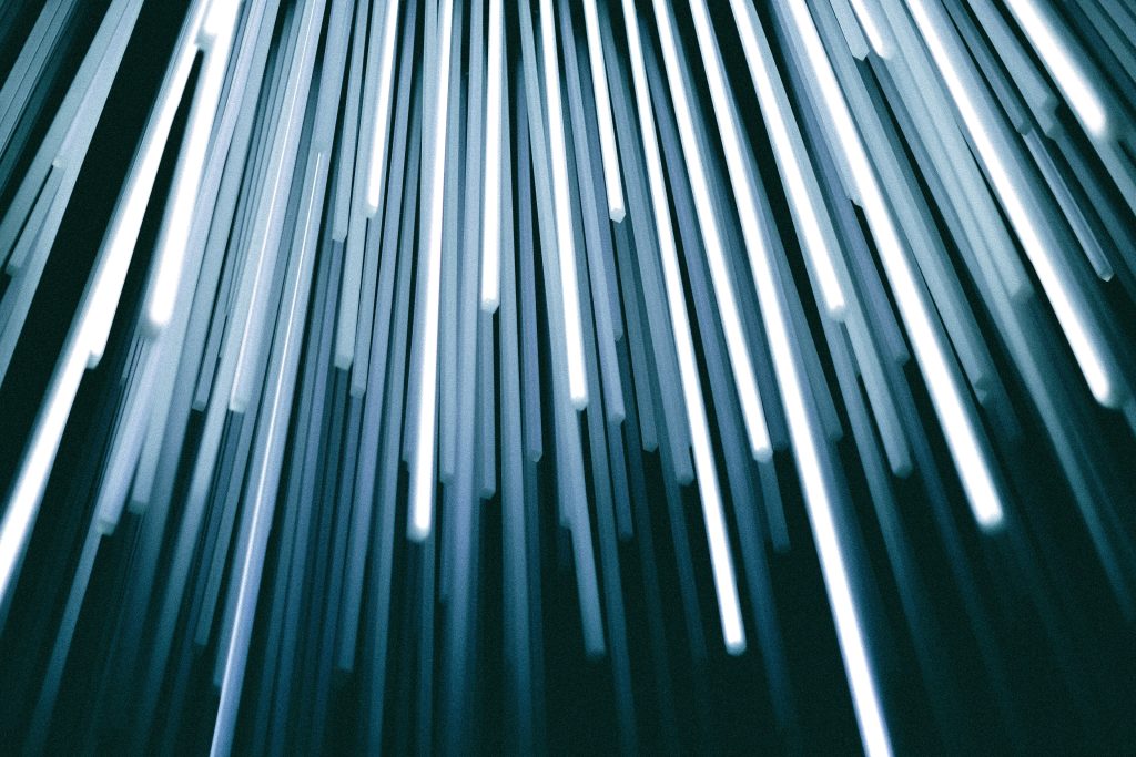 Strands of fibre-optic cable glowing blue at their tips