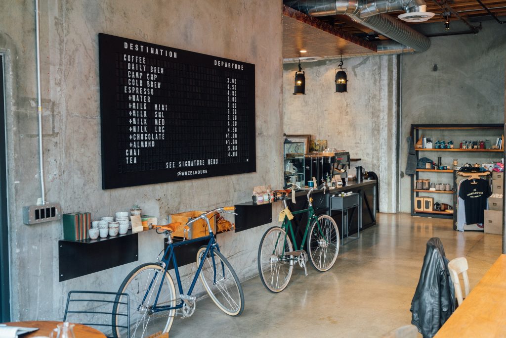 Inside a small coffee shop with bicycles parked by the counter